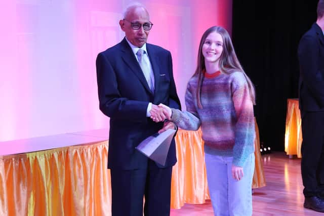 Hollie Mudd receives her bursary from Dr Agrawal.