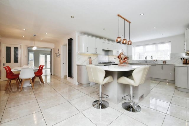 This kitchen is large and modern with plenty of space for a dining room table as well.