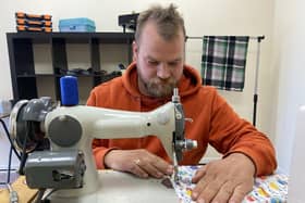 Mark Sanders sewing in his shop, She knits, He Sews, in Murray Street. Picture by FRANK REID