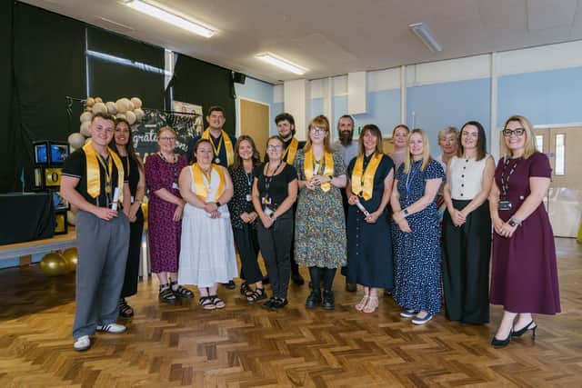 Ad Astra staff with former trainees at a graduation ceremony.