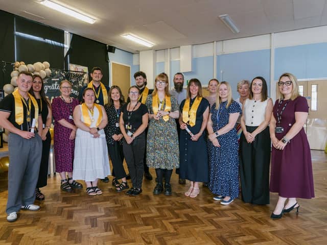 Ad Astra staff with former trainees at a graduation ceremony.