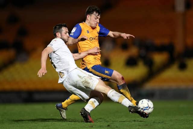BURSLEM, ENGLAND - MARCH 15: Kieran Wallace of Mansfield Town battles for possession with Ben Garrity of Port Vale during the Sky Bet League Two match between Port Vale and Mansfield Town at Vale Park on March 15, 2022 in Burslem, England. (Photo by Lewis Storey/Getty Images)