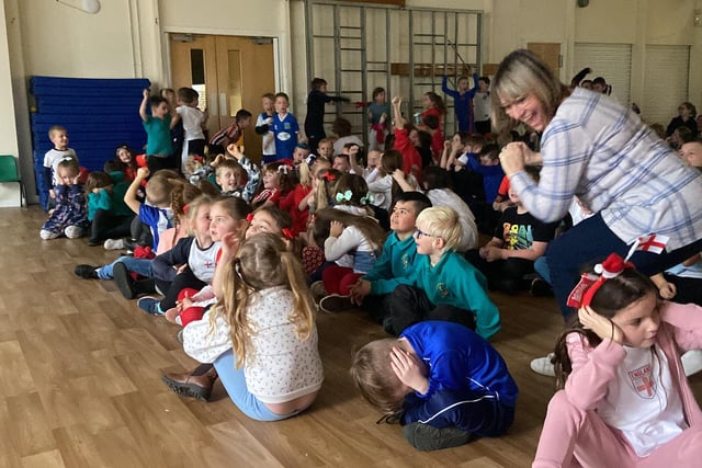 Children and staff at Clavering Primary School celebrate the fifth goal.