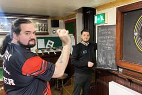 Blacksmiths Arms darts player Jason Boobyer throws his darts as fellow 24hr charity darts marathon player Steve Banner keeps the score. Picture by FRANK REID