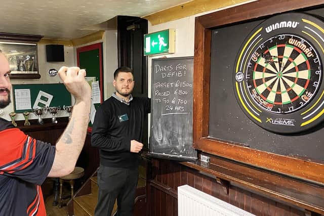 Blacksmiths Arms darts player Jason Boobyer throws his darts as fellow 24hr charity darts marathon player Steve Banner keeps the score. Picture by FRANK REID