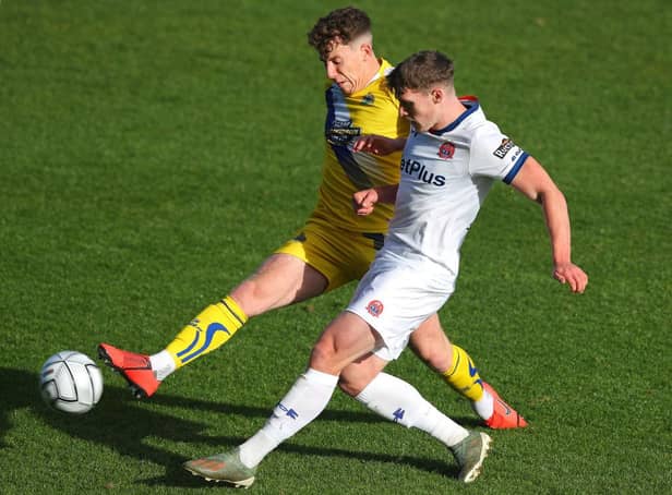 Thomas Peers of Altrincham challenges Reagan Ogle of AFC Fylde during the Emirates FA Cup fourth qualifying round match.