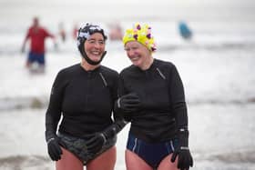 Two swimmers enjoy the benefits of the cold sea.