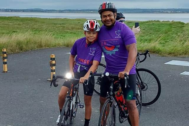 Lewin and his dad Suli on the charity bike ride.