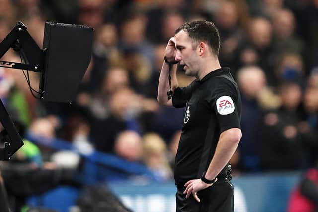 Referee Chris Kavanagh checks the VAR monitor at a Premier League match between Chelsea and Leeds United. (Photo by Marc Atkins/Getty Images)
