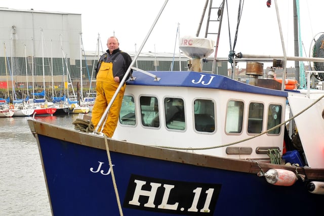 Keith Fletcher stands aboard his fishing boat in 2012.