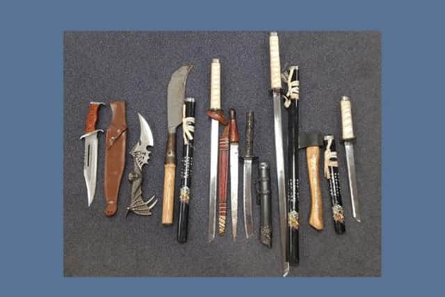 Police seized several weapons and suspected drugs from the property on Powell Street.