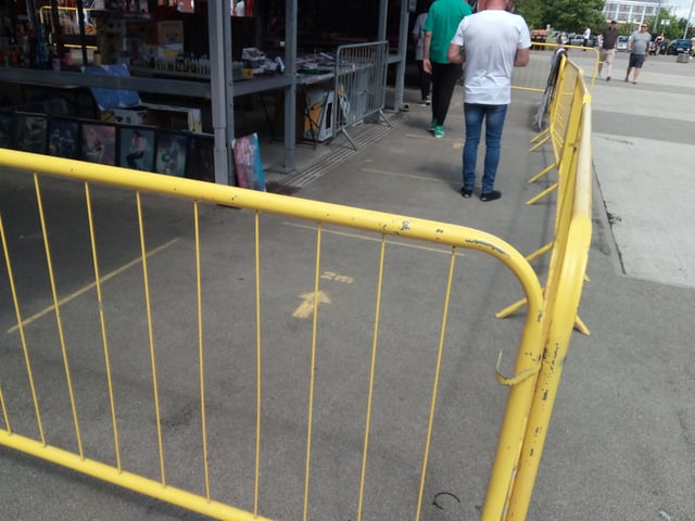 Lines and barriers show how people should keep a 2m distance and abide by a one way system on the outdoor market