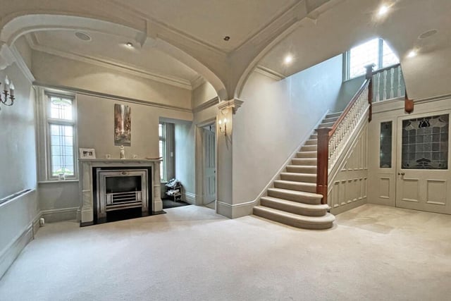 This entrance hall has a homely open air feel and boasts a traditional fireplace.