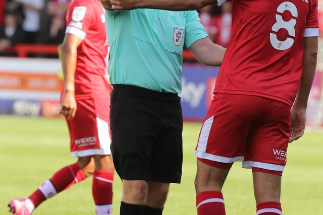 Referee Lee Swabey shows a yellow card to Jack Powell of Crawley Town. It was one of 71 bookings and four reds for the club.