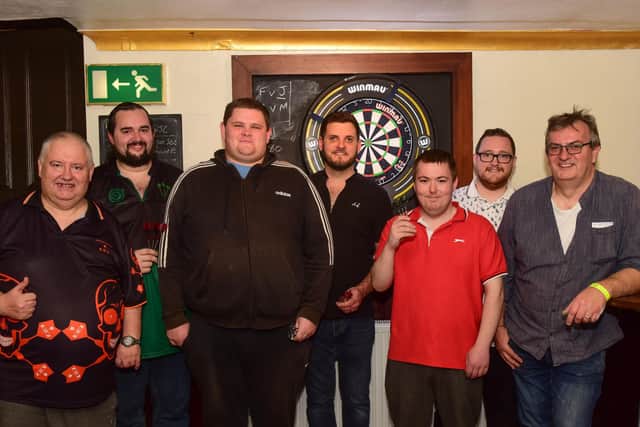 Celebrating success atthe end of the 24-hour darts marathon.