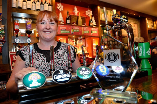 Rebecca Drake, general manager at the Stag and Monkey, gets ready to pull a pint for a customer in 2015.