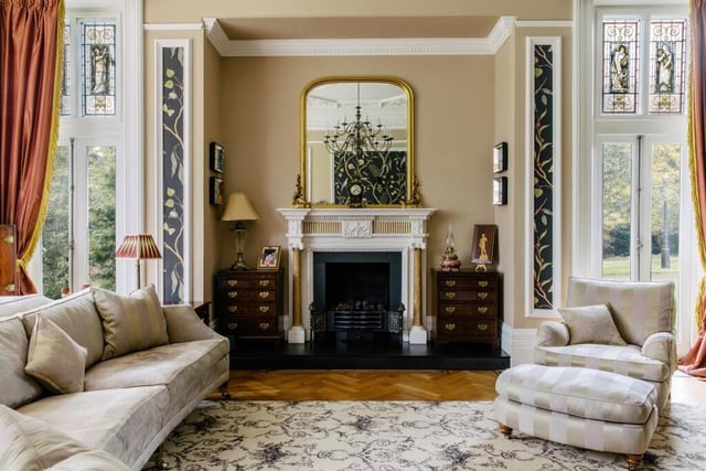 This spacious drawing room has a magnificent fireplace and cosy seating area.