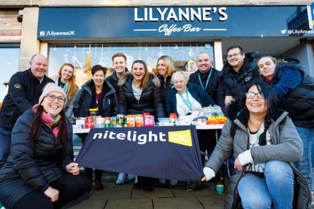 Nite Light CIC and LilyAnne's coffee shop workers with the new stall giving away free food.