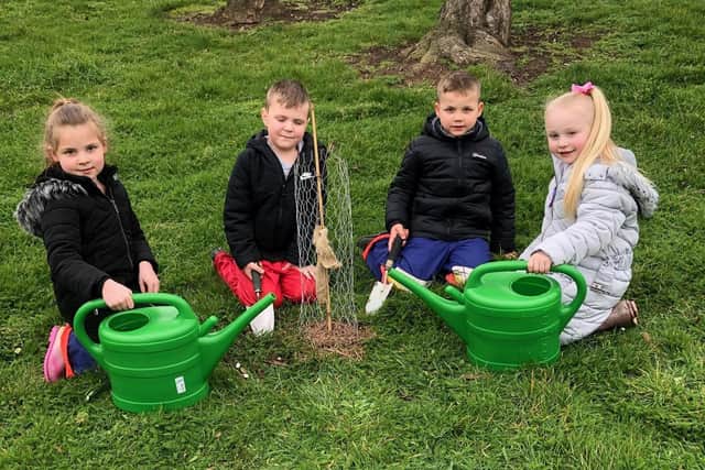 Brougham Primary School pupils plant a tree to mark the start of the project.
