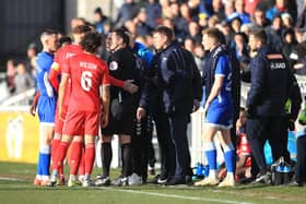 Discussions take place between referee Aaron Jackson and both managers after an alleged racism incident during the Vanarama National League match between Hartlepool United and Ebbsfleet United at Victoria Park.