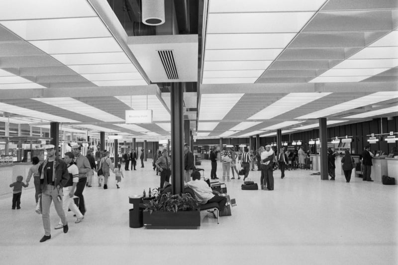 Airline passengers in the main concourse of Edinburgh airport in May 1987.