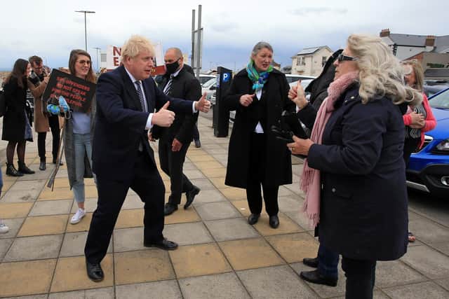 Prime Minister Boris Johnson gestures as he campaigns on behalf of Conservative Party candidate Jill Mortimer (centre) in Seaton Carew ahead of Hartlepool's by-election to be held on May 6. Photo by PA.