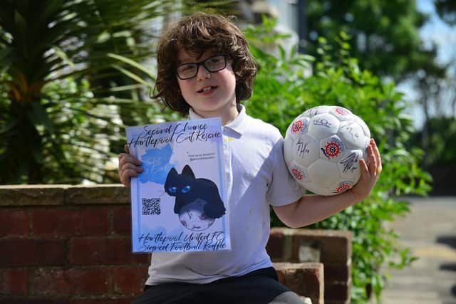 George Tuson with an autographed Hartlepool United ball that is being raffled in aid of Second Chance Cat Rescue.