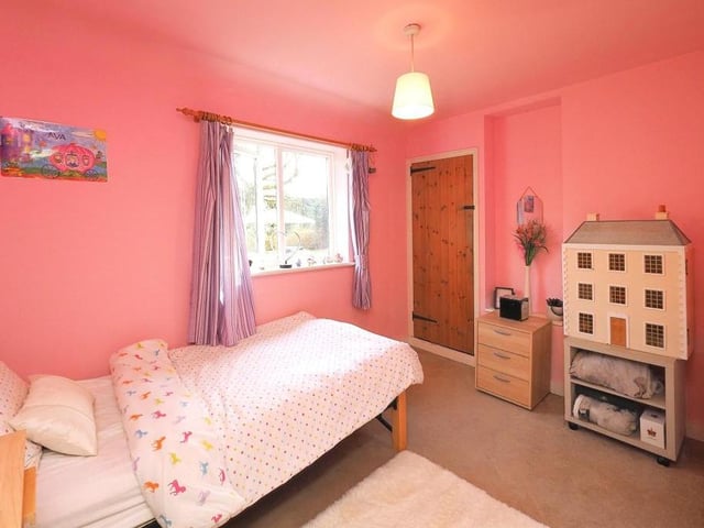 The fourth bedroom is the smallest, but still a nice size. There is a fitted wardrobe, while the window faces the side of the £470,000 cottage.