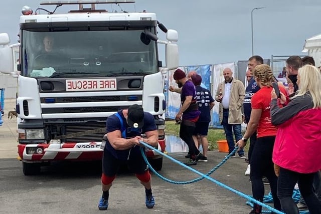 Strongmen and women had a go at pulling a fire engine.