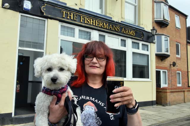 The Fisherman's Arms landlady Hazel Whitelock and pub dog Sunny are ready to welcome customers back.