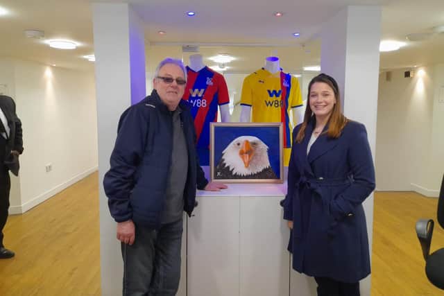 Ron Harnish with a member of staff at Crystal Palace and the painting.