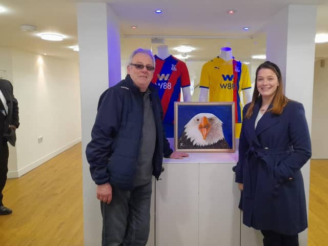 Ron Harnish with a member of staff at Crystal Palace and the painting.