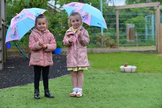 Clavering Primary School pupil Ariya Watson (left) and Isabelle Scholes with their umbrellas./Photo: Frank Reid