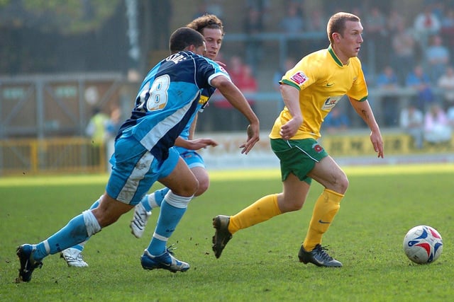 David Foley attempts to escape two Wycombe players.