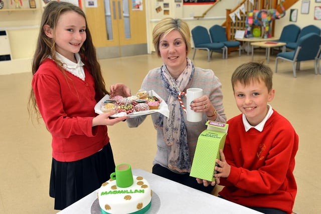 Teaching assistant Fiona Davison is served cake and coffee by pupils Sage Jubb and Joe Cosgrave.
