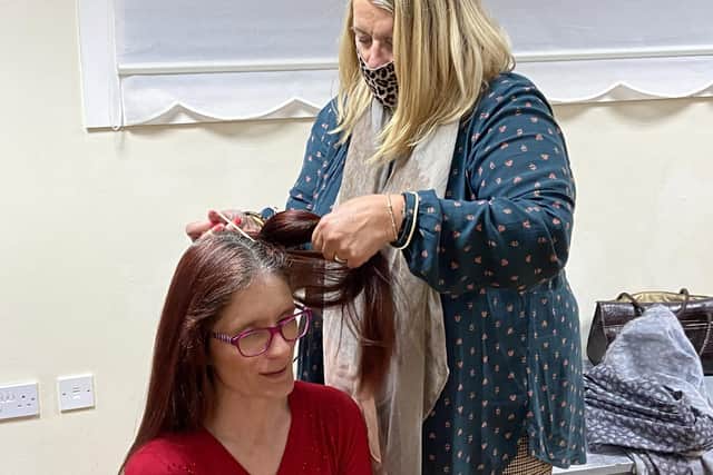 Hairdresser Beverley Scurrah shaving the head of Rachel Jones. Picture by FRANK REID