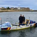 Charlie Fleury and Adam Baker stand in their boat in Hartlepool's harbour.