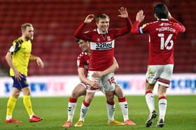 Duncan Watmore of Middlesbrough celebrates with team mates Paddy McNair and Jonny Howson after scoring their side's first goal during the Sky Bet Championship match between Middlesbrough and Huddersfield Town.