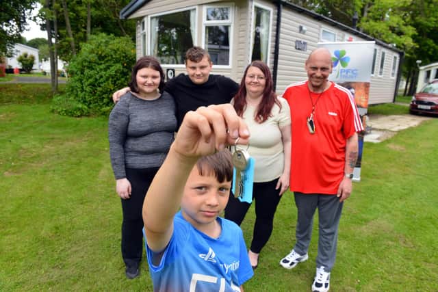 Hartlepool family Darren and Janet Cooper with children Abbey, 16, Freddie, 13 and, front, Alex , nine, with the keys for one of the Hartlepool-based PFC Trust's respite caravans at Cresswell Towers, in Northumberland.