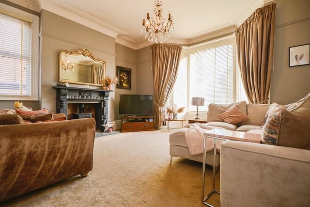 The feature open fireplace with log burner makes the front reception room extra cosy.