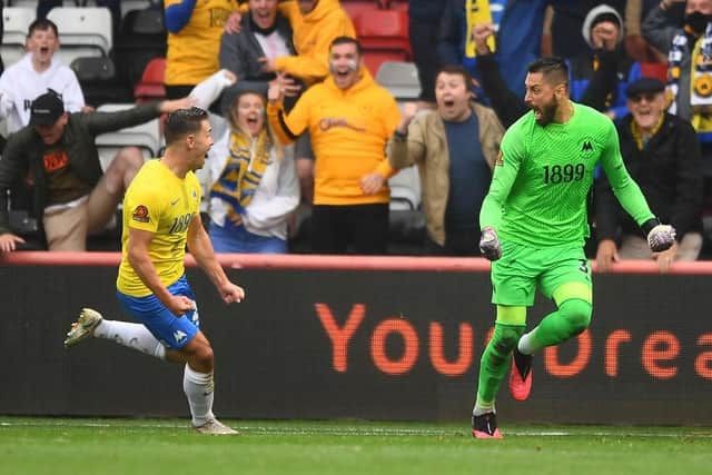 Goalkeeper Lucas Covolan celebrates scoring Torquay United's equaliser during the Vanarama National League play-off final match between Hartlepool United in 2021.