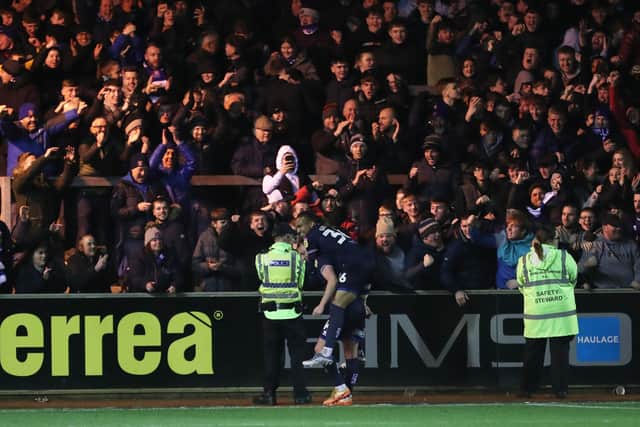 Carlisle United's Kristian Dennis celebrates with John-Kymani Gordon after scoring their third goal. (Credit: Mark Fletcher | MI News)