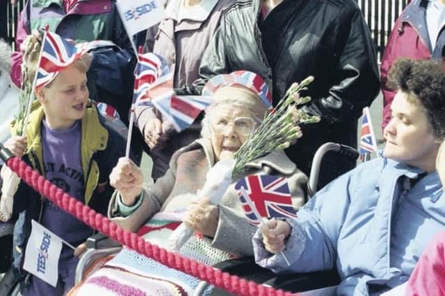 Young and old alike wait to see the Queen.
