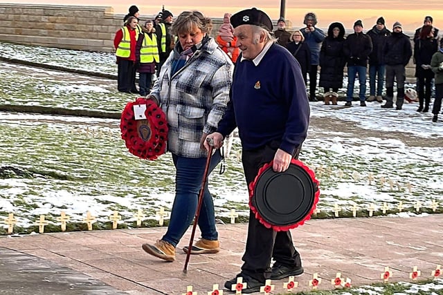 Sian Cameron, from the Royal British Legion, and Councillor John Cambridge, of Headland Parish Council, pay their respects.