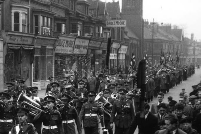 The band of the 4th Battallion Green Howards leads a parade along York Road passing Bruce Moores shops in 1954.