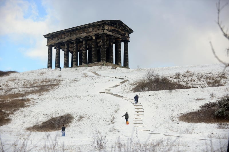 Hardy souls head up to Penshaw Monument through the snow.
