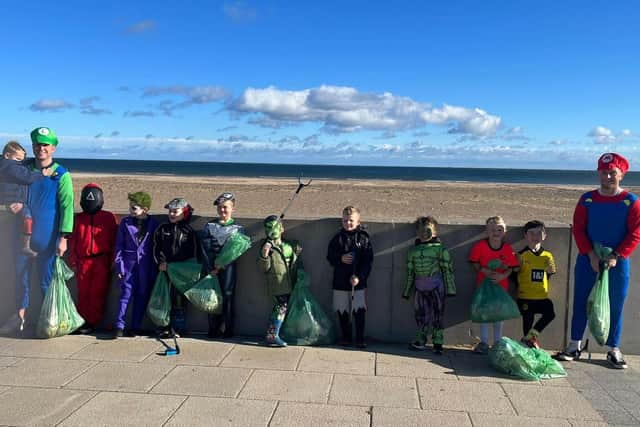 Players and coaches of Seaton Carew FC's under seven team picking litter in Seaton Carew Beach.