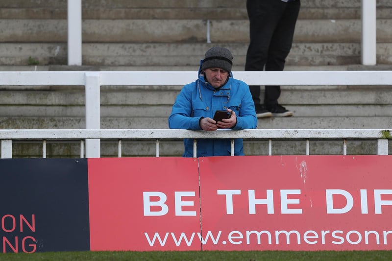 This fan is checking the scores of Pools' rivals.