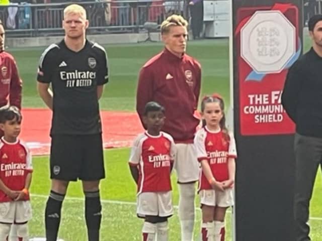 Alice McBride, 6, escorts players onto the pitch at a Wembley football match between Arsenal and Manchester City.