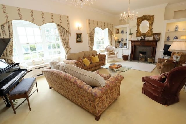 The drawing room enjoys beautiful views and an open fire.